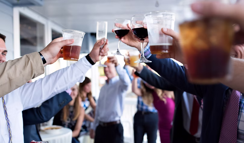Wedding guests raising glasses in a toast at reception
