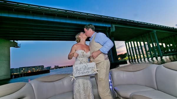Couple walking together in an intimate waterfront setting